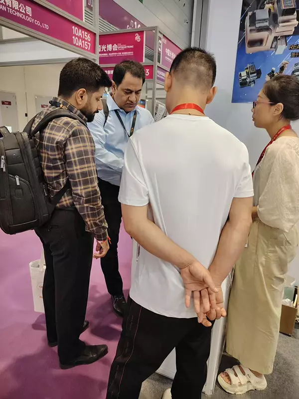 Interacting with and taking photos with clients at CIOE 2025