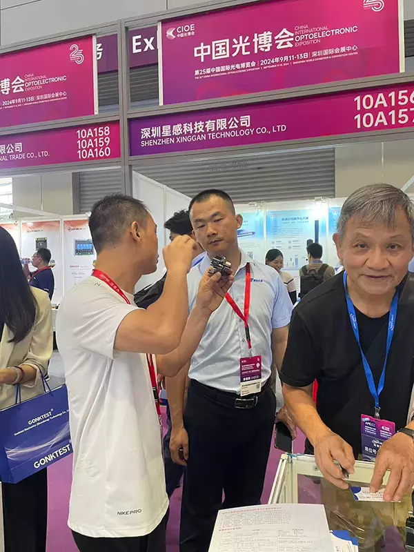 Interacting with and taking photos with clients at CIOE 2025